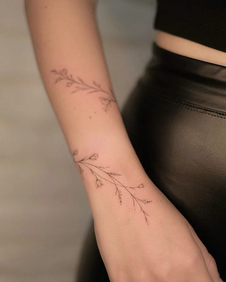 delicately wrapped floral arm tattoo