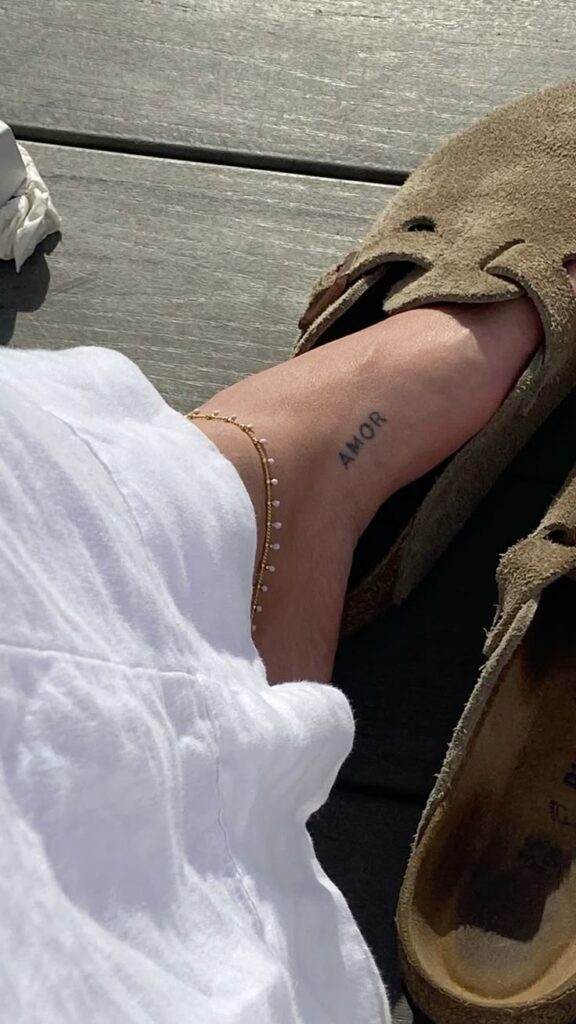 bold font inner foot tattoo