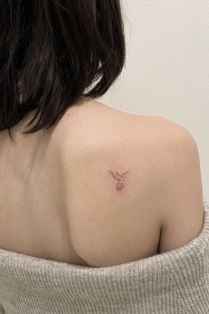 dainty hummingbird tattoo on back