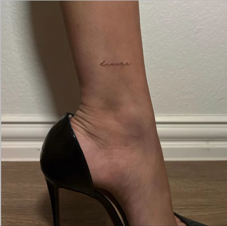 Cursive font feminine leg tattoo